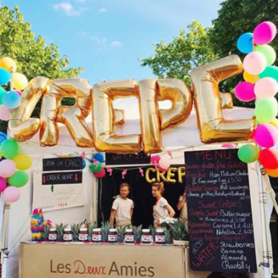 crepe van decorated with balloons at the market