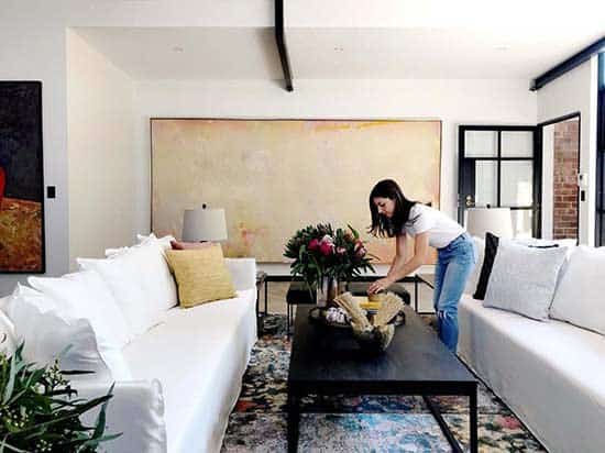 Interior Designer at work decorating a large living room