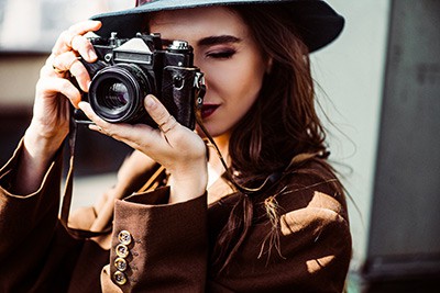 Close up of woman taking a photo with a Nikon camera