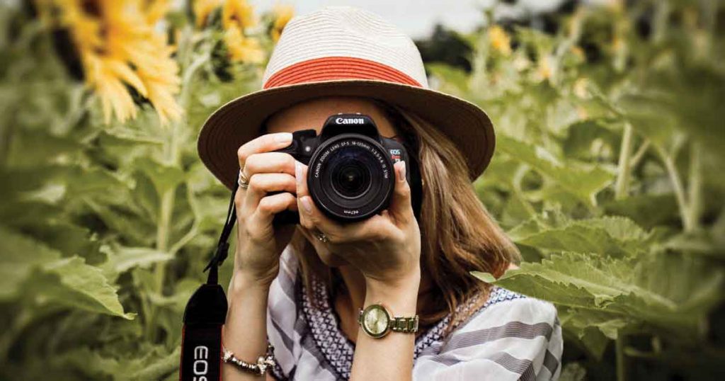 Close up of woman taking a photo with a Nikon camera