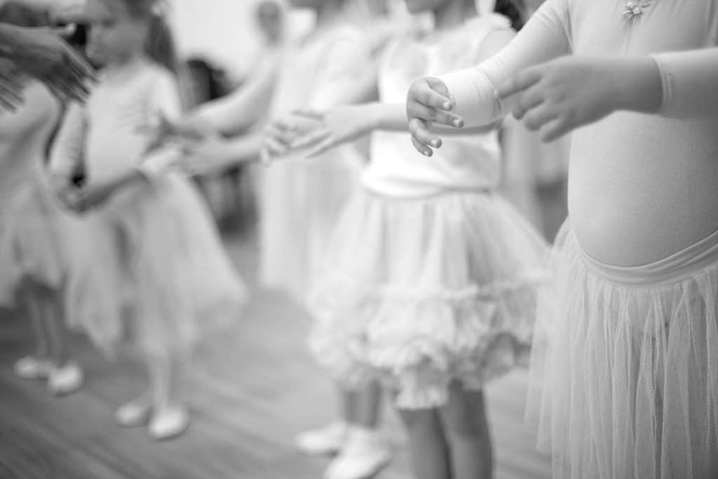Blurred toddler ballerinas in black and white