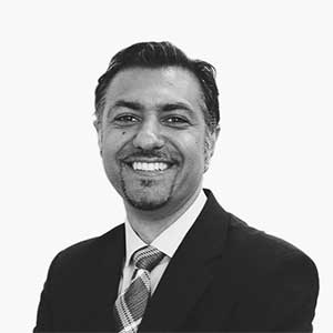 Black and white headshot of Reza Torabi, Head of IT at AUZi Insurance