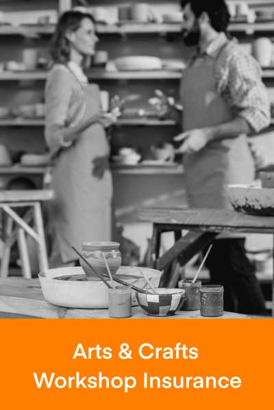 Two people talking at a pottery workshop