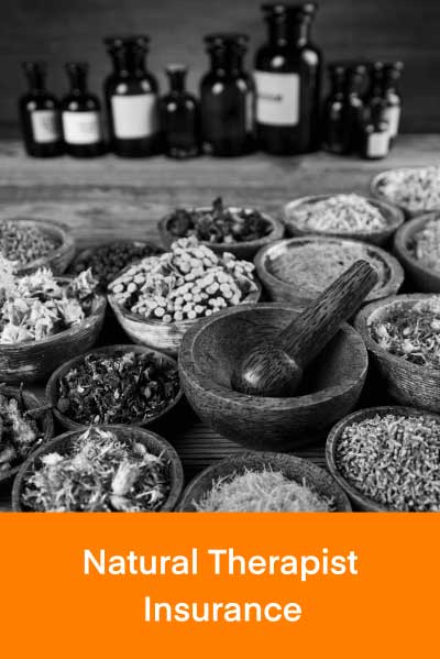 Natural therapy herbs in bowls and a mortar and pestle