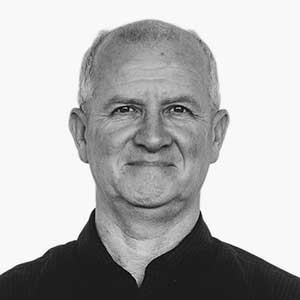 Black and white headshot of Neil Inns, Founder of AUZi Insurance