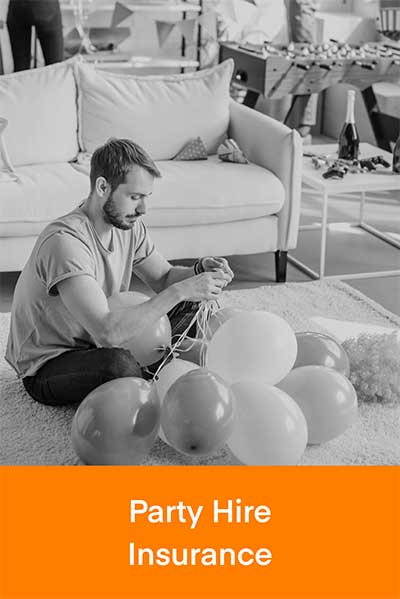 Party hire business owner tying balloons together for an event